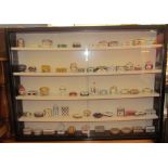 A collection of Del Prado porcelain boxes and covers together with a wall hanging display cabinet