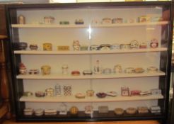 A collection of Del Prado porcelain boxes and covers together with a wall hanging display cabinet