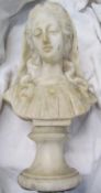 An alabaster bust of a maiden on a socle base