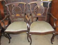 A pair of Edwardian mahogany marquetry decorated elbow chairs,