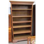 A 20th century oak bookcase the moulded cornice above open shelves