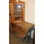 An oak gate leg dining table together with a pine hanging corner cupboard with doll's house
