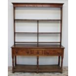 An 18th century South Wales oak dresser, the moulded cornice above three shelves,