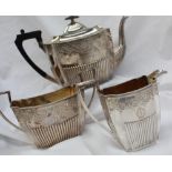 A Victorian silver three piece tea set, comprising a teapot,