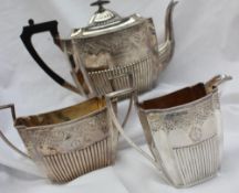 A Victorian silver three piece tea set, comprising a teapot,