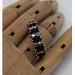 A sapphire and diamond half eternity ring set with ten round brilliant cut diamonds each