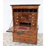 An 18th century walnut secretaire a abatant, the moulded cornice above a cushion drawer,