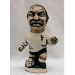 A John Hughes pottery Grogg of Jimmy Greaves in a Tottenham shirt with his foot raised on a ball,
