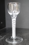 An 18th century English wine glass with a tapering bowl and double helix cotton twist on a