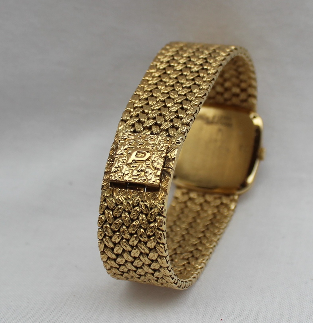 A Lady's 18ct yellow gold Piaget wristwatch, with a black dial and integral bezel and strap, - Image 4 of 5