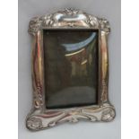 An Art Nouveau silver photograph frame, decorated with stylised flowerheads and leaves, Birmingham,