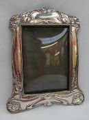 An Art Nouveau silver photograph frame, decorated with stylised flowerheads and leaves, Birmingham,