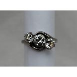 A Three stone diamond ring, the central brilliant cut diamond approximately 0.