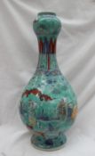 A Chinese porcelain double gourd vase with a turquoise ground, with figures,