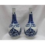 A pair of Chinese porcelain bottle vases, painted with leaves to heart shaped panels,
