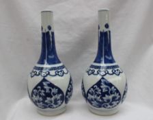 A pair of Chinese porcelain bottle vases, painted with leaves to heart shaped panels,