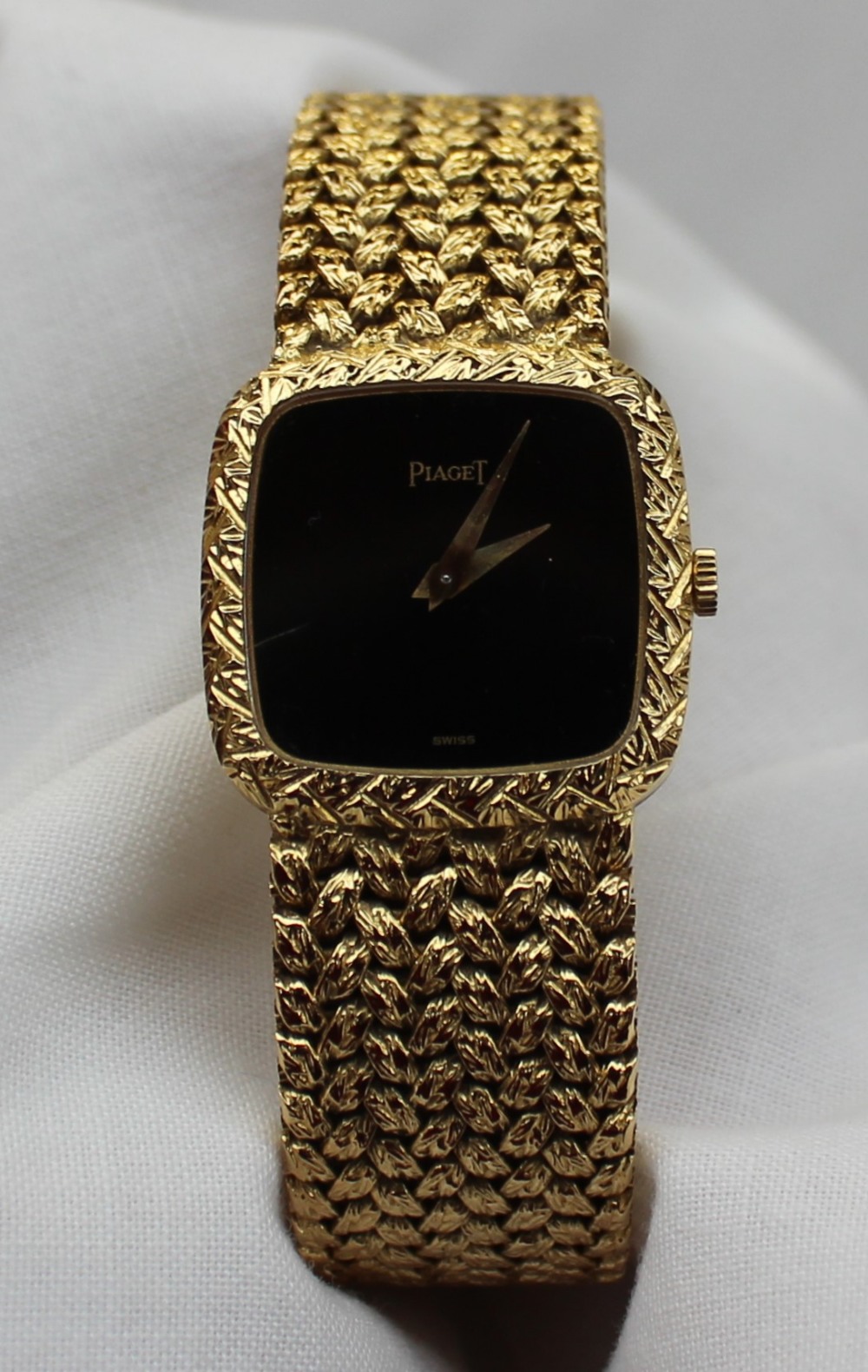 A Lady's 18ct yellow gold Piaget wristwatch, with a black dial and integral bezel and strap, - Image 2 of 5