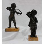 A bronze figure of cupid, on a rectangular marble base,