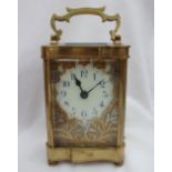 A 19th century French brass carriage clock, with a serpentine case and handle,