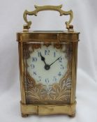 A 19th century French brass carriage clock, with a serpentine case and handle,