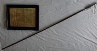 A Zulu spear with a double edged tip, tapering wooden shaft and weighted base,