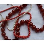 A coral bead necklace with graduated beads approximately 23 grams together with a pearl necklace