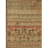 A 19th century sampler, with interlaced flowers and leaves to the border with alphabet and numbers,