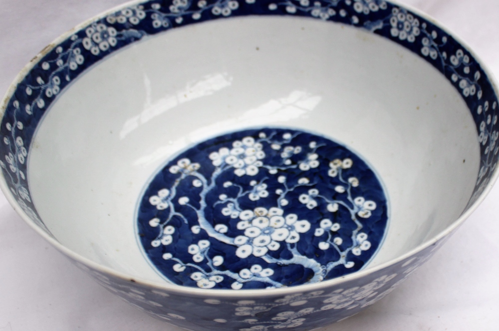 A Chinese porcelain bowl decorated inside and out in the prunus blossom pattern,
