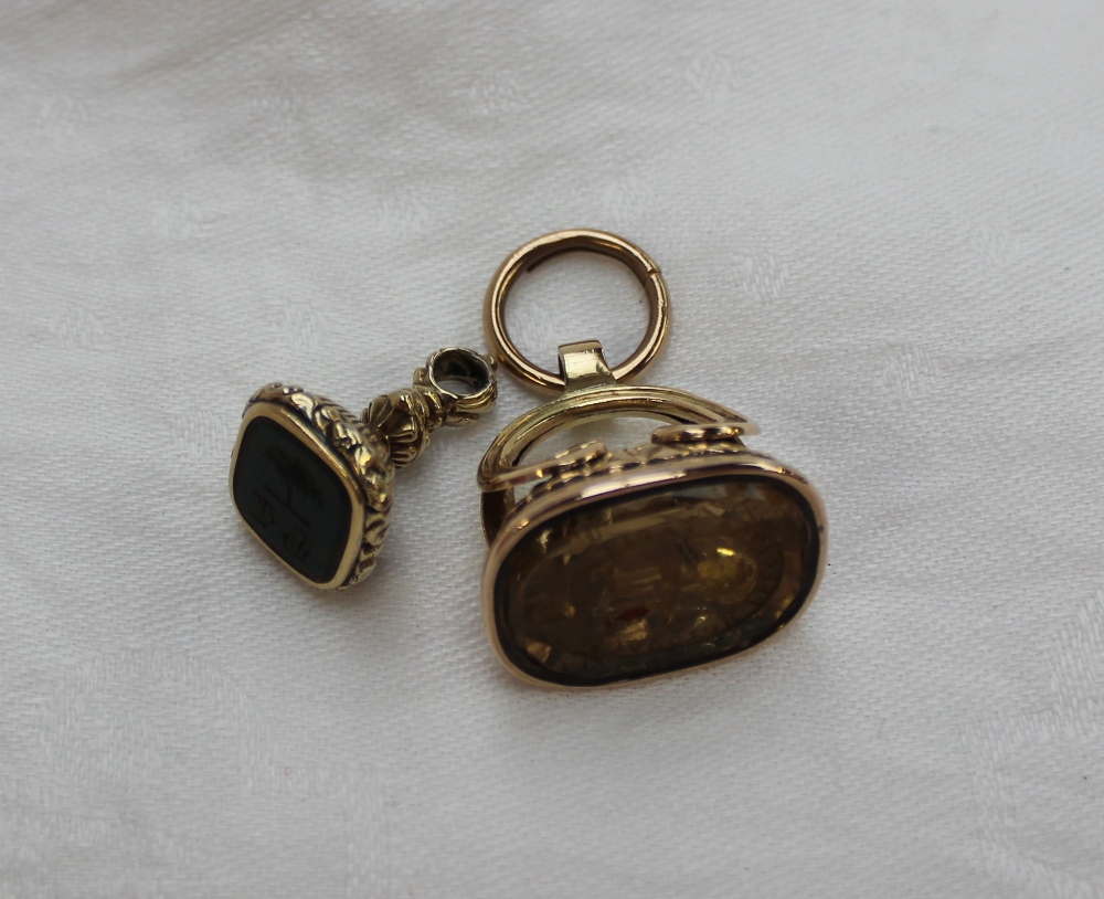 A yellow metal fob seal,