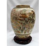 A large Japanese Satsuma pottery vase decorated with figures amongst cherry blossom trees with