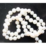 A pearl necklace set with sixty-two graduated individually knotted pearls to a yellow metal clasp