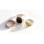 A 9ct yellow gold signet ring, set with an onyx panel together with a garnet,