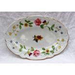 A Nantgarw porcelain oval dish with a moulded scrolling edge,