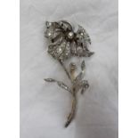 An Edwardian diamond brooch, in the form of a flower head and stem,