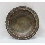 A middle eastern copper and white metal bowl, with a lobed edge,