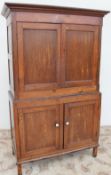 An 18th century oak linen press, the moulded cornice above a pair of cupboard doors,