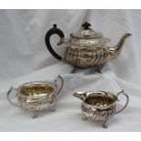 A late Victorian silver three piece teaset, comprising a teapot,
