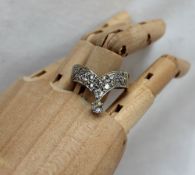 A diamond set ring, set with old round cut diamonds to a white metal setting and shank,