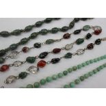 A jade bead necklace together with a hardstone graduated bead necklace,