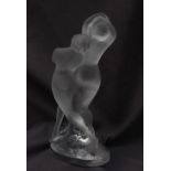A Lalique glass model of two frosted glass nude dancers, on an oval base, signed "Lalique France",