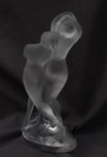 A Lalique glass model of two frosted glass nude dancers, on an oval base, signed "Lalique France",