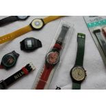 A Tin Tin Swatch watch, cased together with two other Swatch watches,