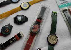 A Tin Tin Swatch watch, cased together with two other Swatch watches,