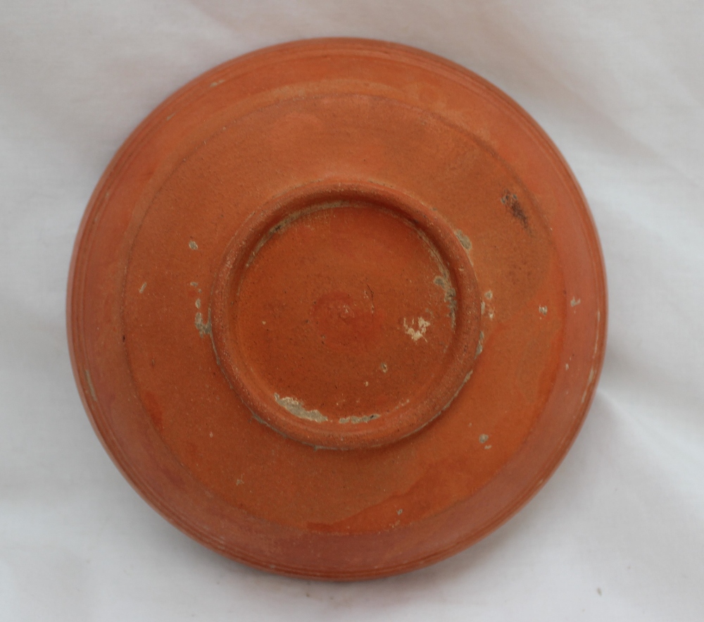 A Roman red ground terracotta bowl, Arretine ware, with a ridged body on a raised foot, - Bild 4 aus 4