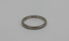 A platinum wedding band, approximately 3 grams,