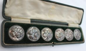 A set of six Edwardian silver buttons, decorated with putti to a rope twist border, Birmingham,