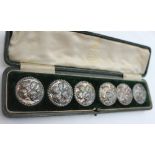 A set of six Edwardian silver buttons, decorated with putti to a rope twist border, Birmingham,