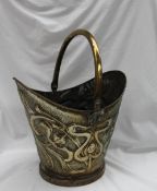 An Art Nouveau stamped brass coal scuttle, embossed with stylised flower heads and tendrils,