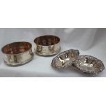 A pair of Elizabeth II silver bottle coasters of plain ring turned form with a wooden base,