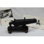 A Carron Company "Carronade" model cannon, on a metal base and brass wheels,